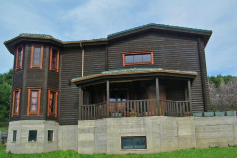 Wooden house with tree trunks